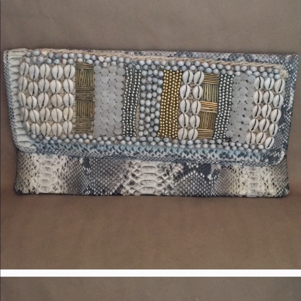 Andi Bagus puka shell snakeskin clutch
